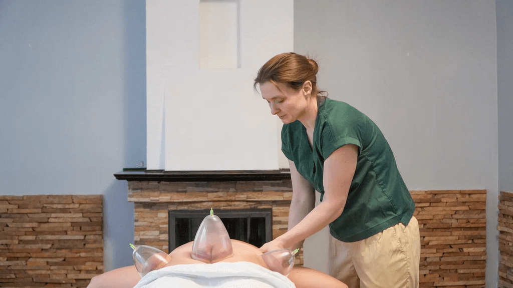 A massage therapist provides a back massage.